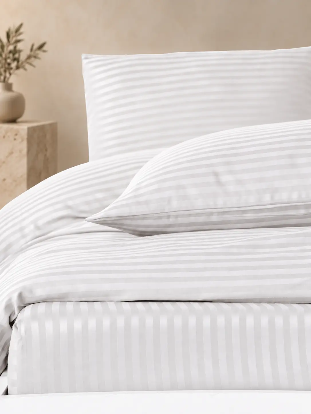Warm-white satin stripe hotel bedding detail